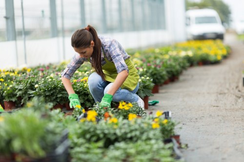 Team member preparing garden tools at a Bow property entrance